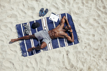 Young man relaxing on the beach