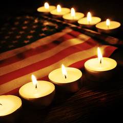 flag of the United States and lighted candles