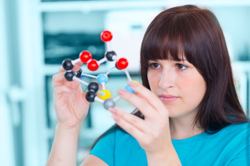 girl student holding a model of chemical molecules