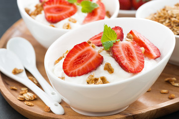 healthy breakfast - yogurt with fresh strawberries, granola