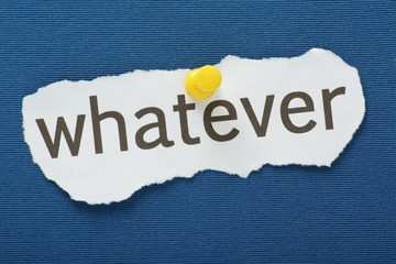 The word Whatever pinned to a blue notice board