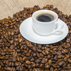 coffee beans and cup of coffee. Selective focus.