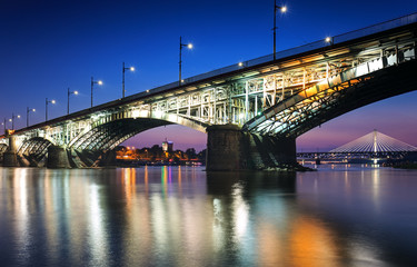 Fototapeta na wymiar Two bridges illuminated in Warsaw