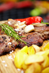 Grilled T-bone steak seasoned with spices and fresh herbs