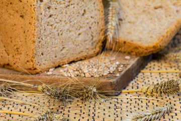 Homemade bread on a rustic scene with wheat