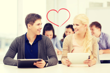 students looking at tablet pc in lecture at school