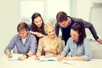 smiling students with notebooks at school