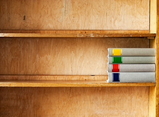 four new books on a wooden shelf