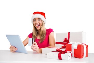 Festive blonde shopping online with tablet