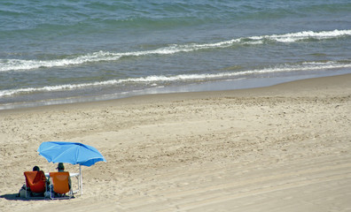 pareja en la playa con sombrilla