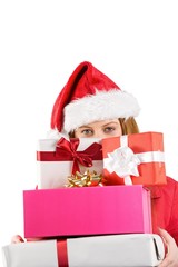 Festive redhead holding pile of gifts