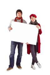 Couple holding a large sign