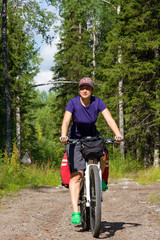 Fototapeta premium girl on the bicycle in the forest
