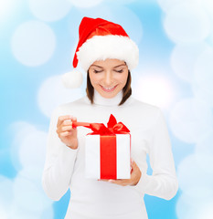 smiling woman in santa helper hat with gift box