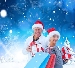 Composite image of couple with shopping bags and gifts