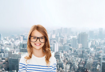 Fototapeta premium smiling cute little girl with black eyeglasses