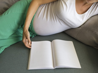Pregnant woman with book