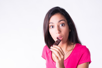 beautiful young woman eating chocolate guilty attitude