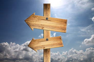 Wood sign on blue sky.