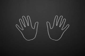 Drawing two hands on the blackboard