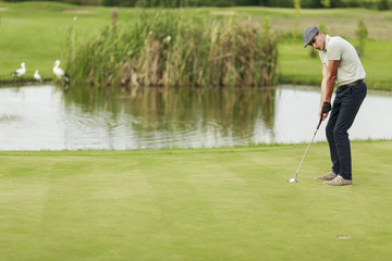 Fototapeta premium Young man playing golf