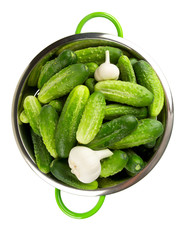 fresh cucumbers in a green colander