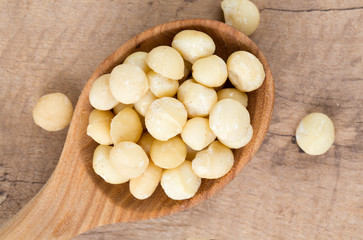 macadamian nuts in a wooden spoon