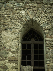 old stone castle wall with vertical windows