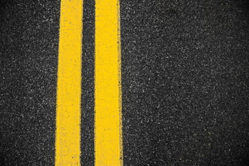 Highway surface with two yellow lines. Asphalt background