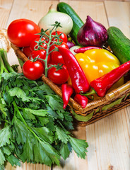 Close up of various colorful raw vegetables in a basket