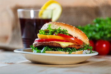 hamburger and drink with slice of lemon