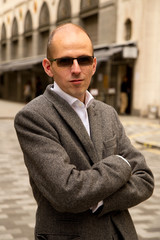 man poses in street.