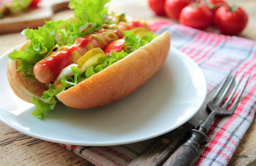 Hot dog with sausage and fresh vegetables