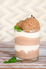 Tasty chocolate mousse with sorbet on wooden table