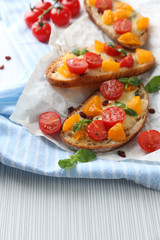 Tasty bruschetta with tomatoes, on table