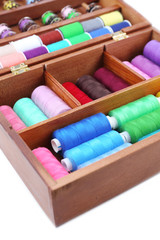 Fototapeta na wymiar Colorful threads for needlework in wooden box close up