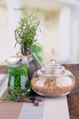 Estragon drink on wooden table on bright background