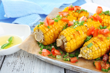 Grilled corn cobs on table, close-up