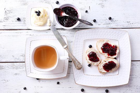 Fresh toasts with homemade butter and blackcurrant jam