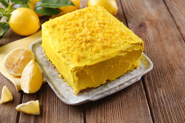 Tasty lemon cake on wooden table