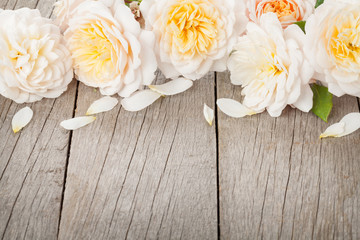 Wooden background with fresh rose flowers