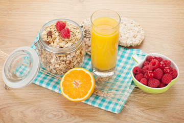 Healthy breakfast with muesli, berries and orange juice