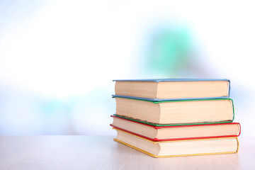 Books on wooden table on natural background