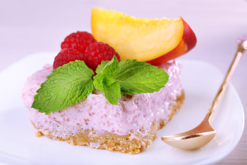 Cake with fruits and berries on plate on wooden background