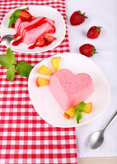 Cakes with fruit and berries on plate on napkin