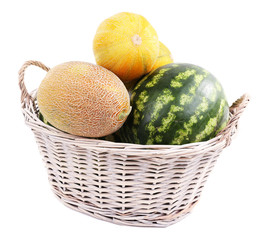 Melons and watermelons in basket isolated on white