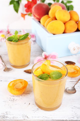 Apricot dessert in glasses on table close-up