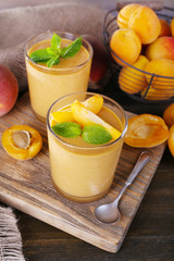 Apricot dessert in glasses on table close-up