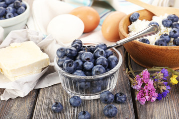 Fresh blueberries and milk products on wooden table