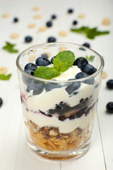 Natural yogurt with fresh berries on wooden table